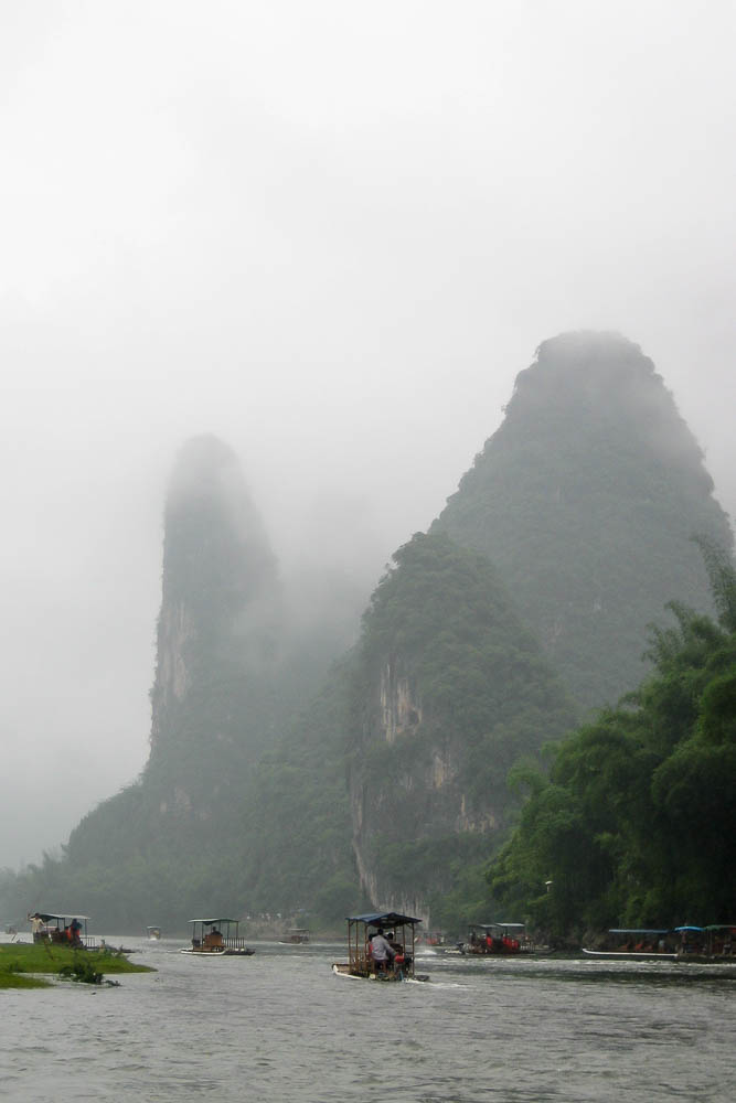 Green rolling hills of Guilin, China covered in fog